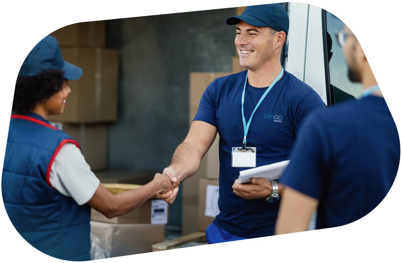 A smiling carGO Health medical courier, leaning on a stack of boxes in a delivery vehicle.